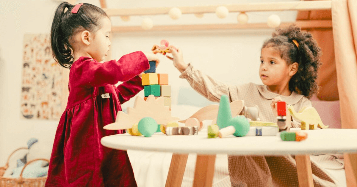 two 4-year-olds playing with toys at a table, fun toys for 4-year-olds