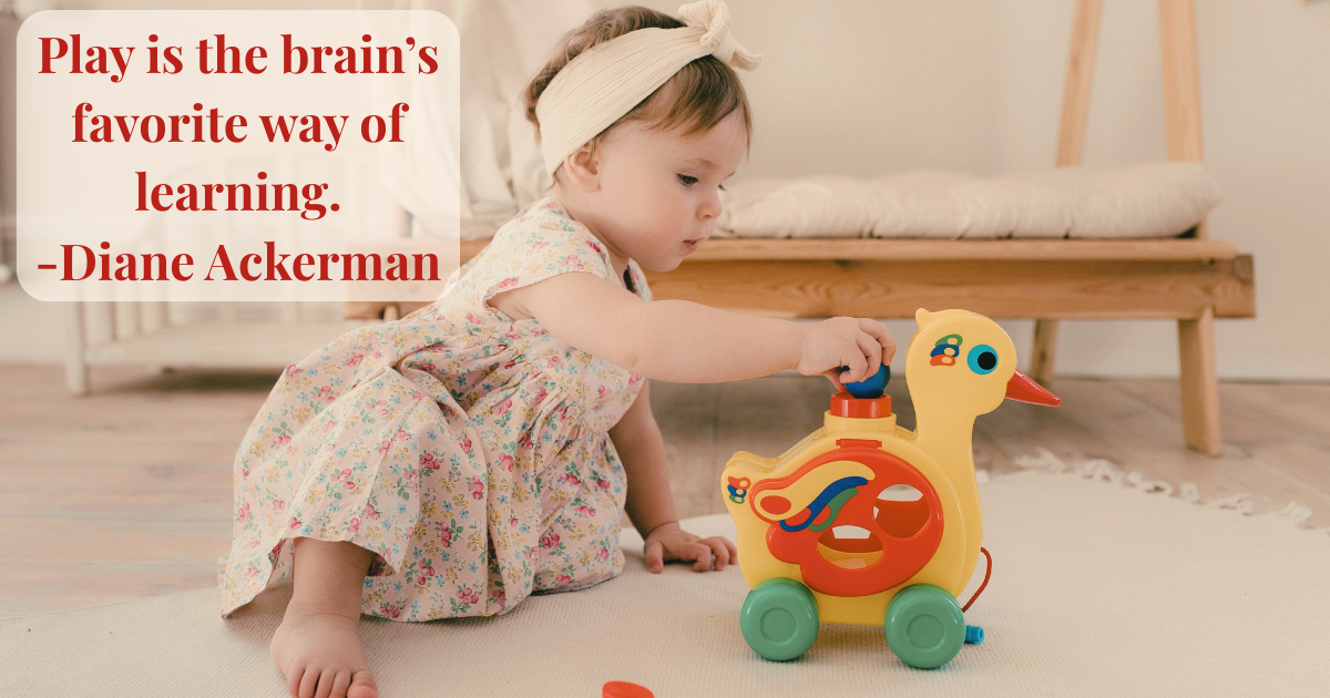Pretend play toys for toddlers. 2-year-old playing with push-pull wooden duck toy.