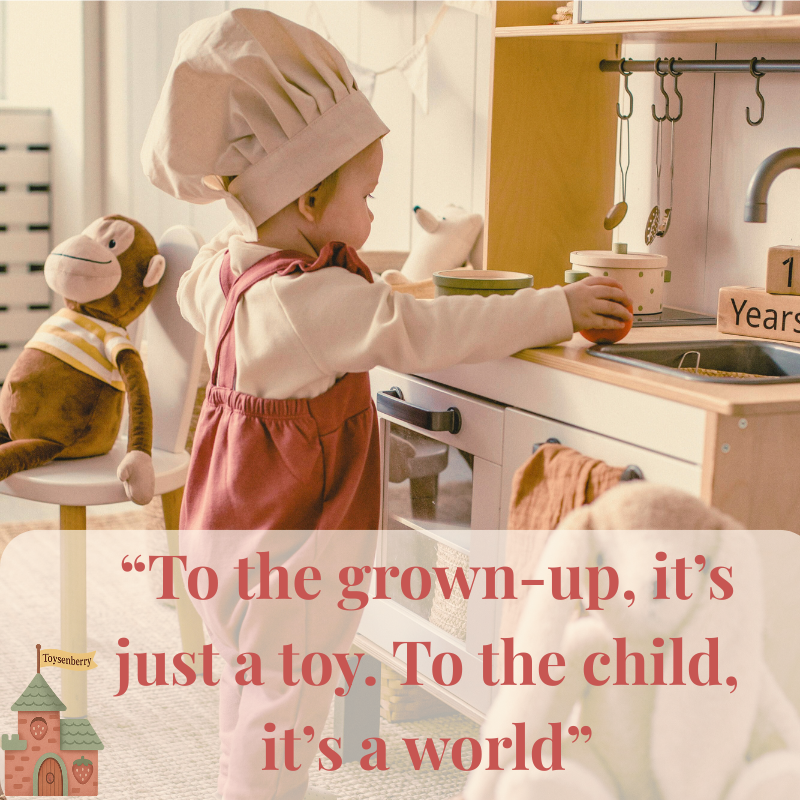 toddler with chef hat playing in a toy kitchen